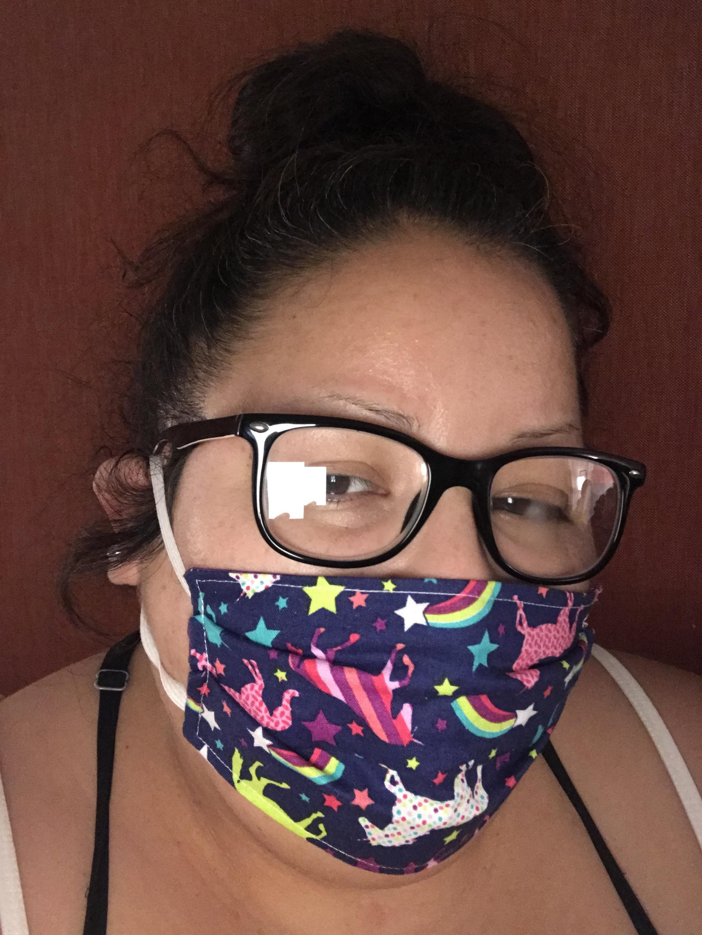 Selfie of a woman with a mask and glasses.